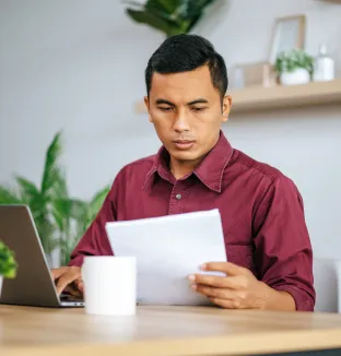 Hombre revisando papeles para solicitar revisión de reclamo